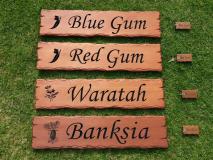 Cedar signs carved and engraved with tree names, bush flowers and matching key rings for an Australian Airbnb retreat