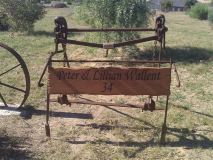 Rustic timber farm sign with property number.