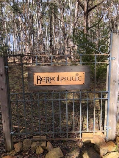 sign hanging on gate made from victorian ash