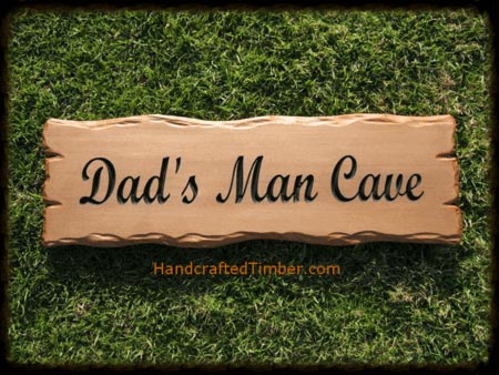 a wooden man cave sign crafted from rustic cedar timber with carved wood edges