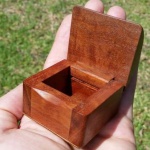 Photo of a small wooden box with lid open