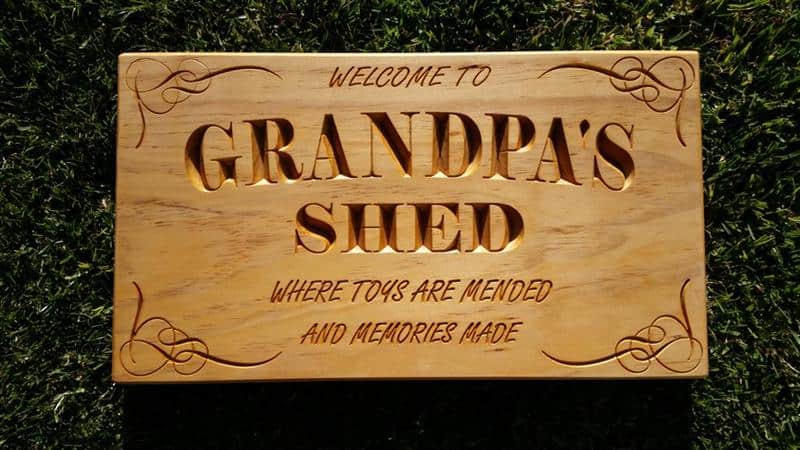 Wooden sign engraved Welcome to Grandpa's Shed where toys are mended and memories made