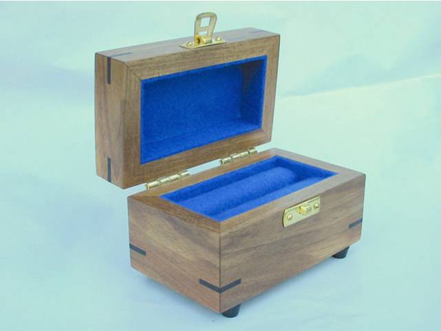 Photo of a small wooden box for a rare stone, lid is open.