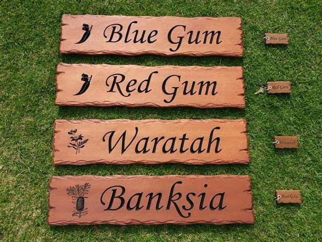 Cedar signs carved and engraved with Australian tree names, bush flowers and matching key rings for an Airbnb retreat