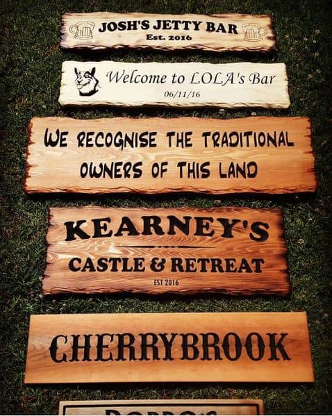 wooden signs and plaques in various styles including rustic cedar and burnt with flame
