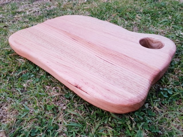 chopping board with a rustic edge and hole