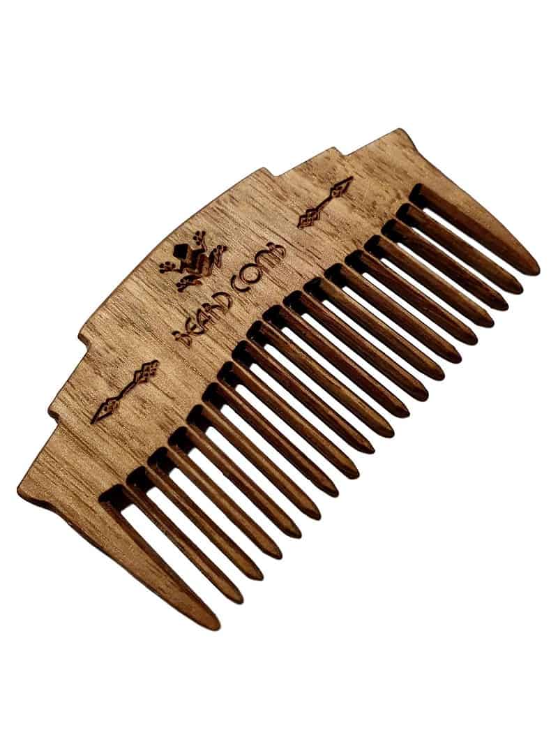 hand crafted wooden beard comb closeup image on white background
