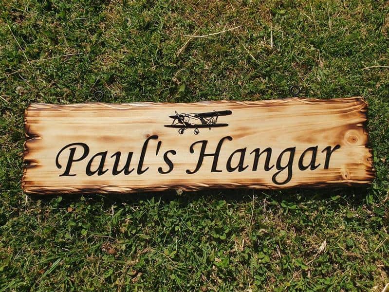 sign made from New Zealand pine reads Paul's Hangar with engraved aeroplane