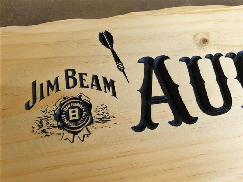 Jim Beam logo engraved into New Zealand Pine with darts for a shed sign