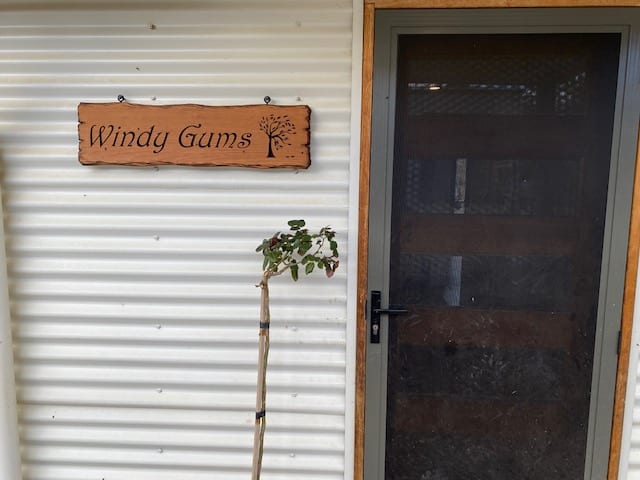 cedar sign at front door - windy gums with tree swept over