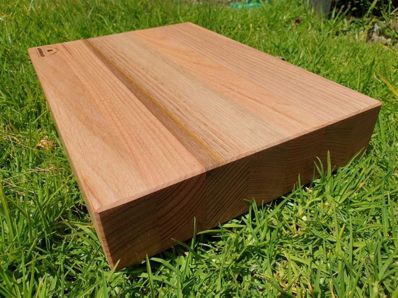 End grain photo of chopping board on grass made from Australian timbers