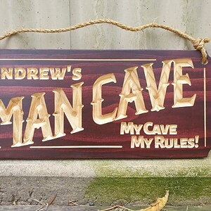 man cave sign personalised Andrews my cave my rules on front of shed with hemp rope and mahogany stain