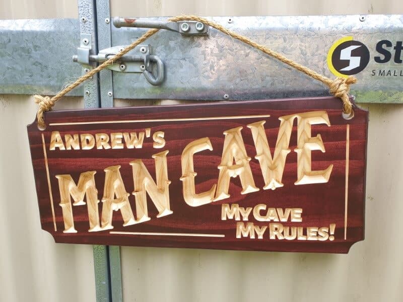 man cave sign Andrew's my cave my rules hanging on shed with hemp rope