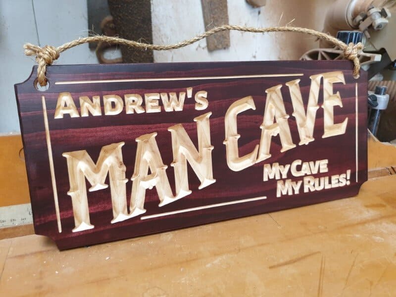 man cave sign Andrews my cave my rules sitting on bench with hemp rope and mahogany stain