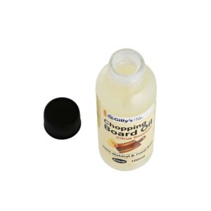 Bottle of chopping board oil with the lid open containing a blend of citrus oils and beeswax.