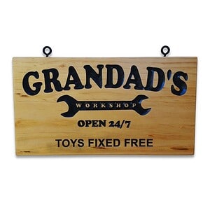 Engraved pine sign with ‘Grandad’s Workshop’ inside a spanner graphic and the text ‘Open 24/7 Toys Fixed Free’.