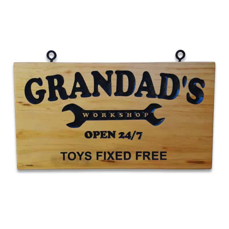 Engraved pine sign with ‘Grandad’s Workshop’ inside a spanner graphic and the text ‘Open 24/7 Toys Fixed Free’.